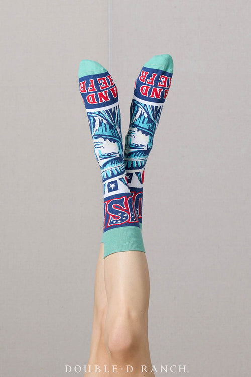 Pair of turquoise crew socks with Statue of Liberty faces and red-white-blue accents