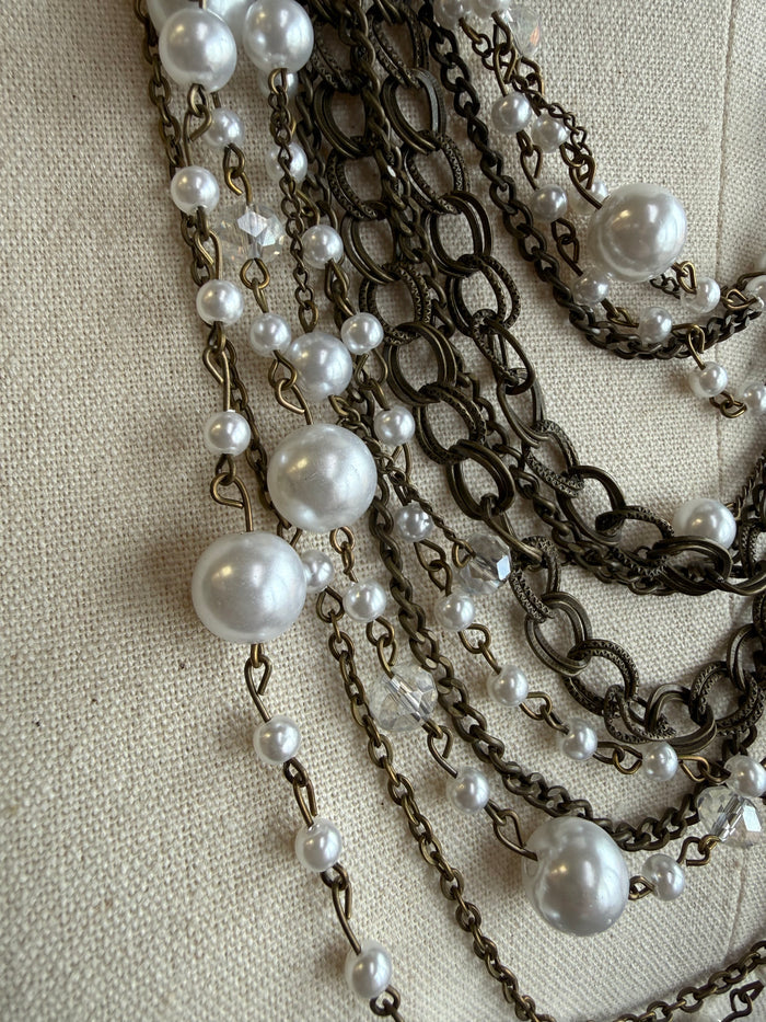 Layered pearl and chain necklace with white pearl drops and dark link chains