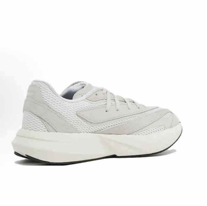 White low-top running shoes with textured panels, lace-up closure, and chunky sole.