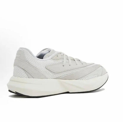 White low-top running shoes with textured panels, lace-up closure, and chunky sole.