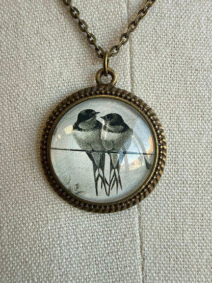 Round glass bird pendant on bronze chain