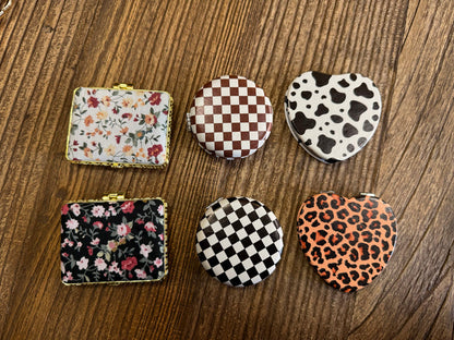 Assorted mirror compacts set with floral, checker, cow-print and leopard-heart patterns