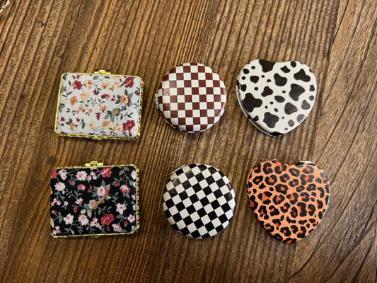 Assorted mirror compacts set with floral, checker, cow-print and leopard-heart patterns
