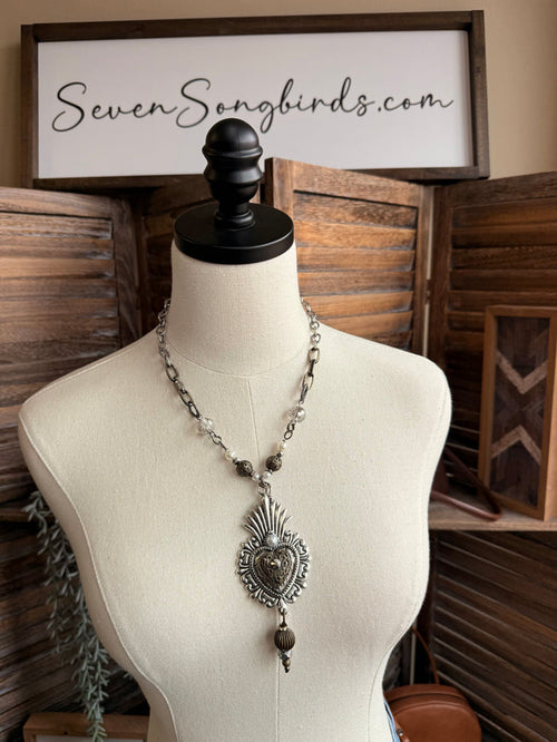 Heart pendant necklace on mannequin with gunmetal chain and dangling black bead drops