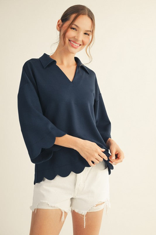 Dark navy V-neck shirt with 3/4 sleeves and scalloped hem, front view