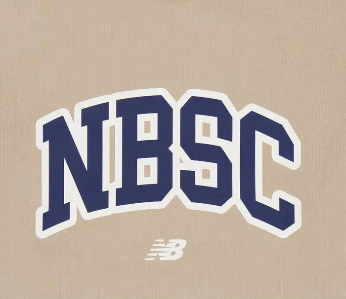 New Balance NBSC T-shirt logo close-up, blue NBSC print on tan