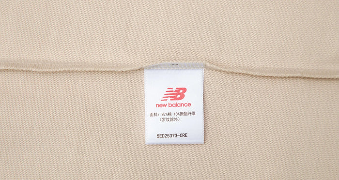 Cream T-shirt with neck/size tag detail