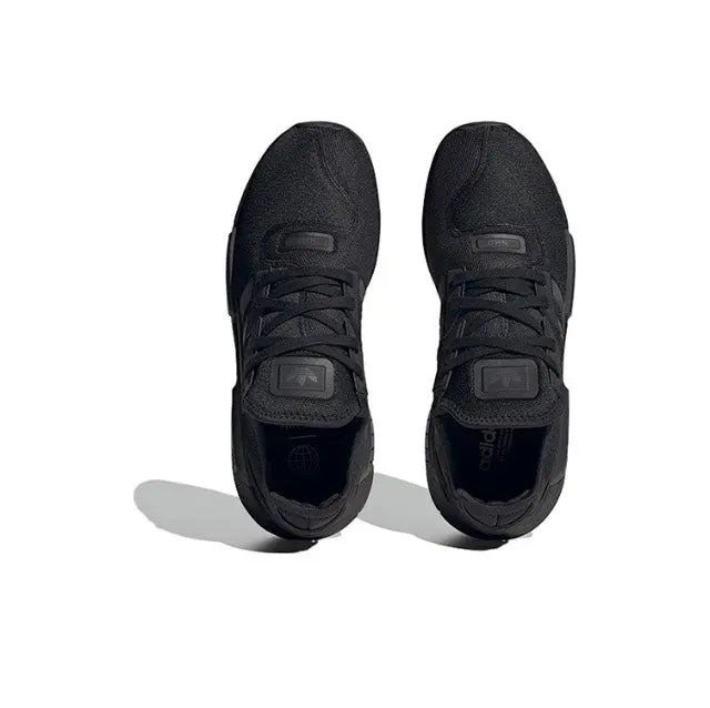 Low-top sneakers pair, black knit upper with lace-up closure and logo patch