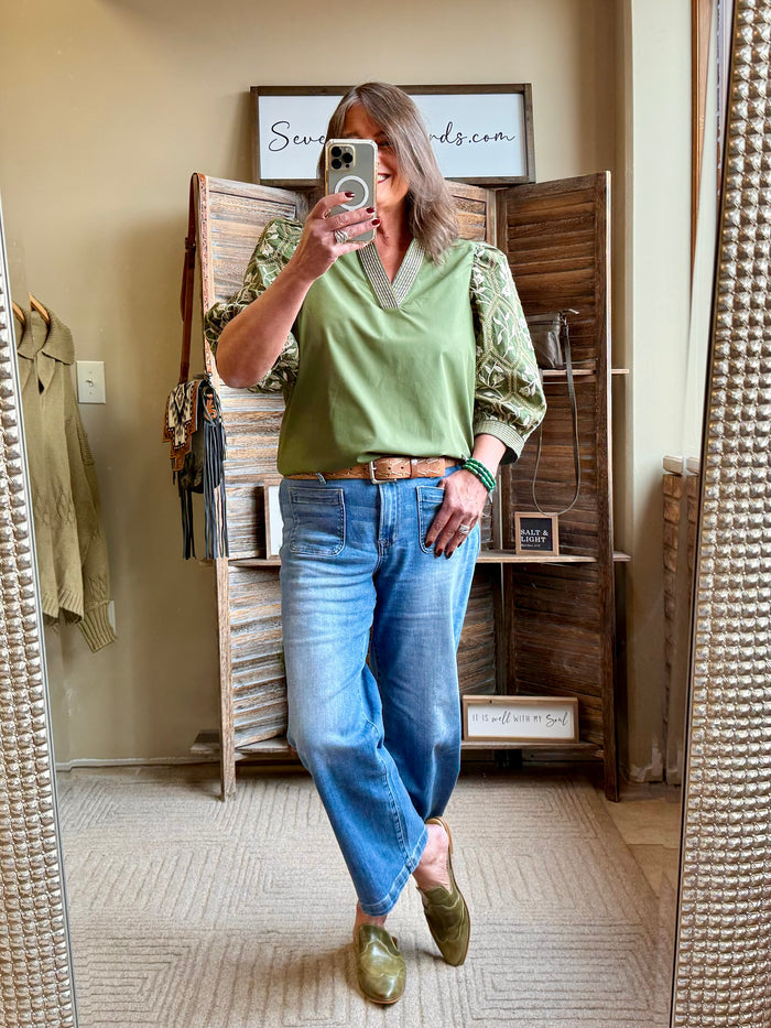 Olive green embroidered sleeve V-neck shirt, front view with detailed cuffs