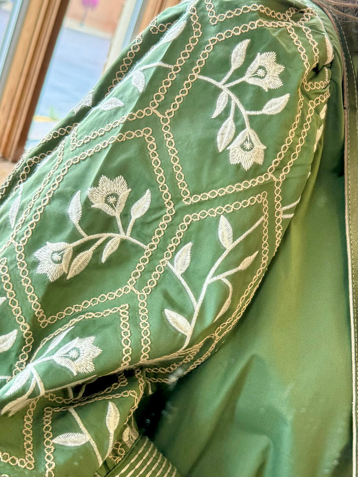 Olive green embroidered sleeve with floral and chain-style white stitching