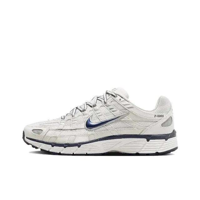 Nike P-6000 premium running sneaker in white with blue swoosh and dark sole