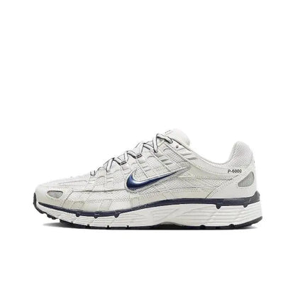 Nike P-6000 premium running sneaker in white with blue swoosh and dark sole