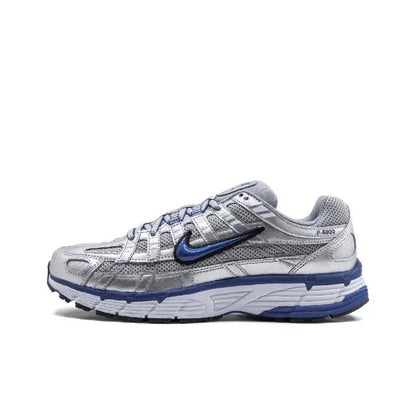 Nike running shoe in silver and blue, mesh/synthetic upper, lace-up with Swoosh.
