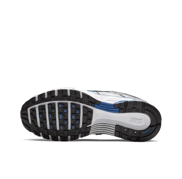 Nike running shoe outsole in dark rubber with blue accents, treaded traction sole.