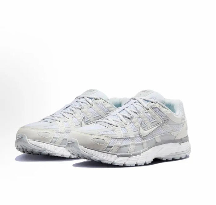 Nike P-6000 Premium sneakers, white with light blue accents, angled side view