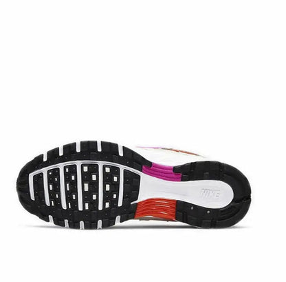 White and purple sneaker outsole with tread and red midsole panel