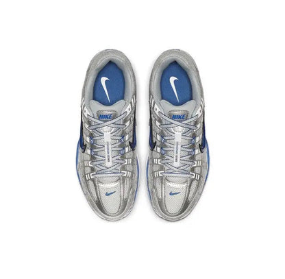 Nike running shoes, silver laces and panels with blue lining, front view pair.