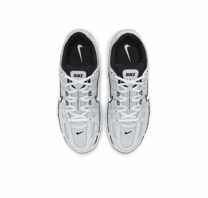 Pair of gray Nike P-6000 sneakers with white laces and black accents