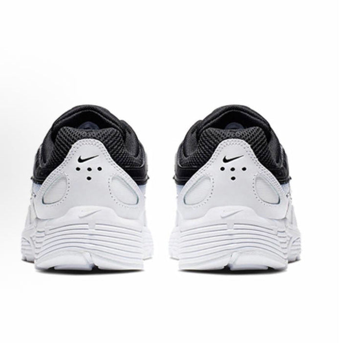 Black and white Nike sneakers, heel view with padded collar and foam midsole