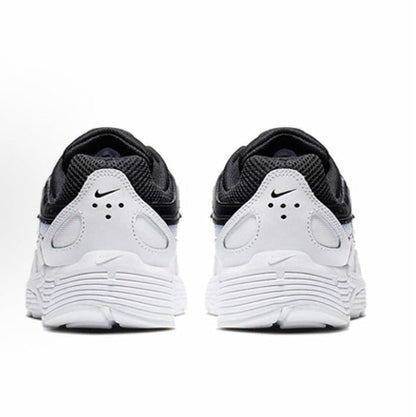 Black and white Nike sneakers, heel view with padded collar and foam midsole