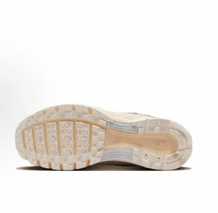 Nike P-6000 Premium outsole view, beige tread with NIKE lettering