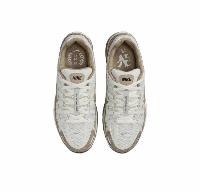 P-6000 premium sneaker pair, light cream uppers with Nike logo on tongue