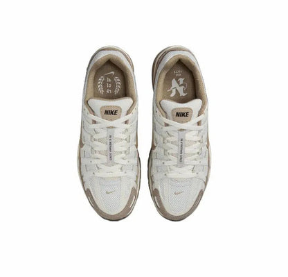 P-6000 premium sneaker pair, light cream uppers with Nike logo on tongue