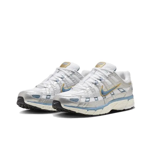 White sneakers with blue side panels and gold Swoosh, lace-up low profile