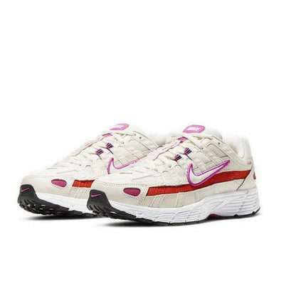 White running sneaker side view with purple swoosh, red stripe, and chunky sole
