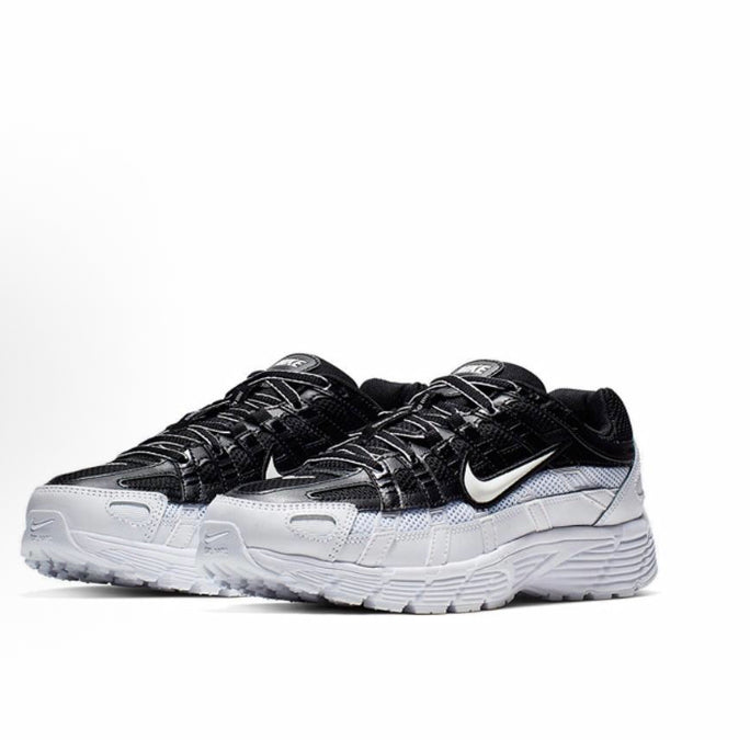 Black and white Nike sneakers, mesh upper with swoosh and lace-up design