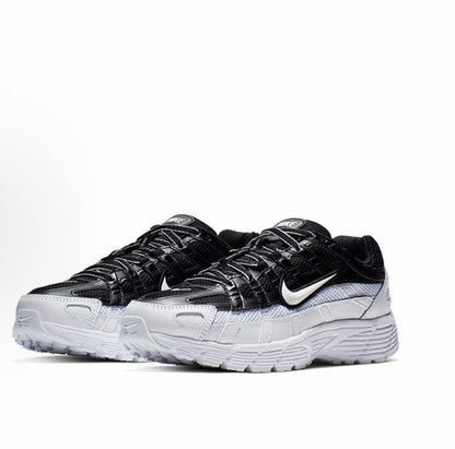 Black and white Nike sneakers, mesh upper with swoosh and lace-up design