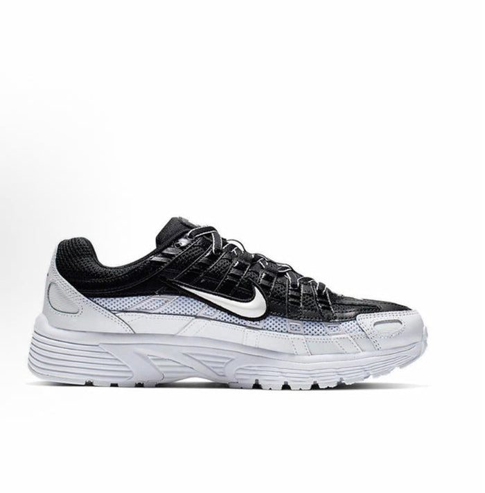 Black and white Nike sneakers with swoosh, lace-up front, and thick midsole