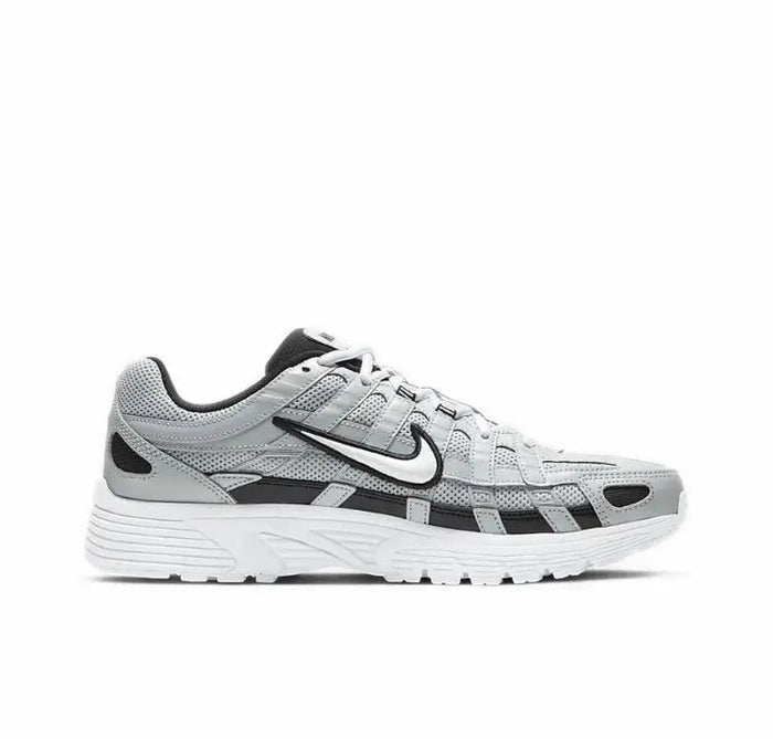 Gray Nike P-6000 sneaker side profile with black stripe detail and white sole