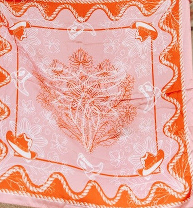 Pink wild rag scarf with orange rope border and floral center print.