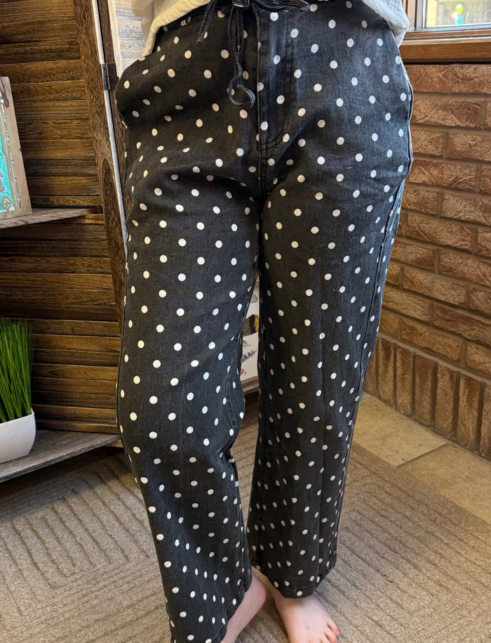 Dark polka-dot jeans with zip-front and front patch pockets, full front view