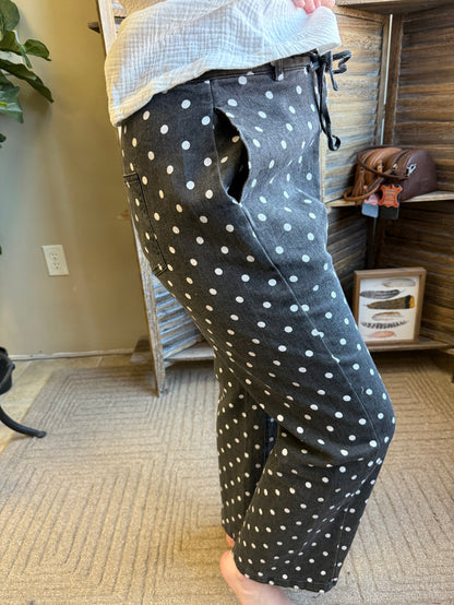 Dark polka-dot jeans, angled side view, zipper front and side pockets