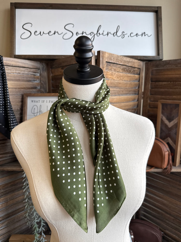 Polka dot wild rag scarf in green with white dots, tied in a knot