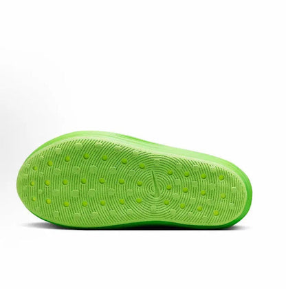 Green outsole with textured traction pattern and circular logo