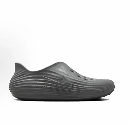Grey slip-on clog side view with swoosh and wavy midsole ridges