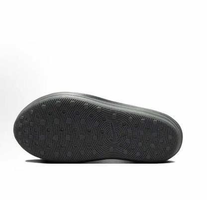 Grey clog outsole with textured tread pattern