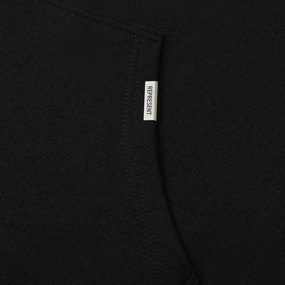 Black hoodie sleeve with Represent brand tag