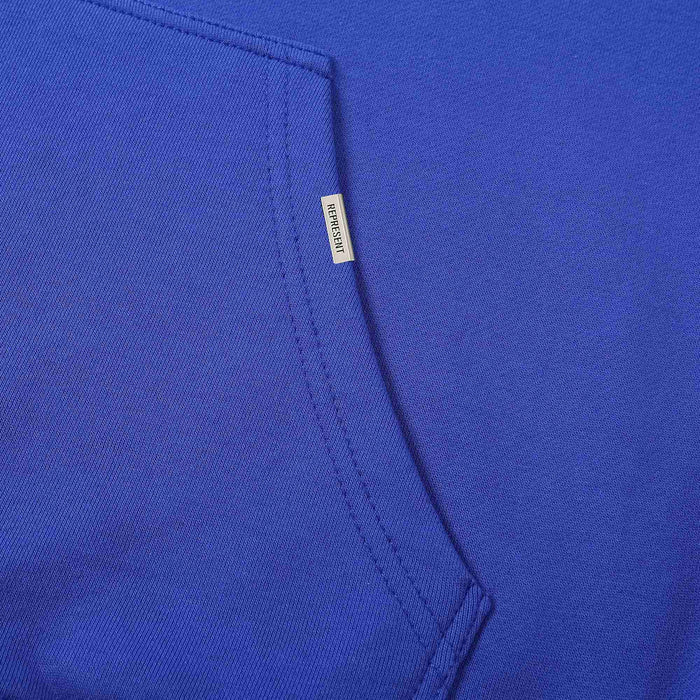 Blue hoodie fabric and inner pocket seam with small brand label tag