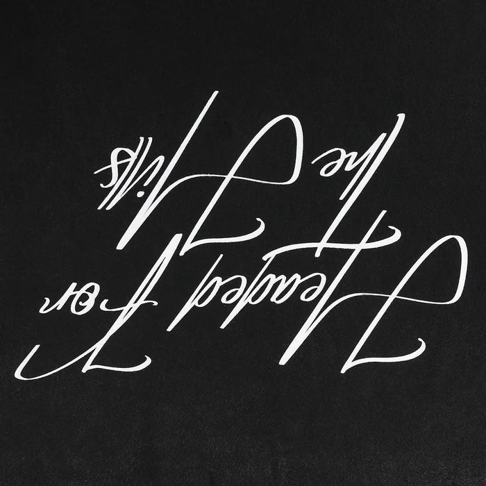 Black T-shirt close-up of large white script graphic lettering