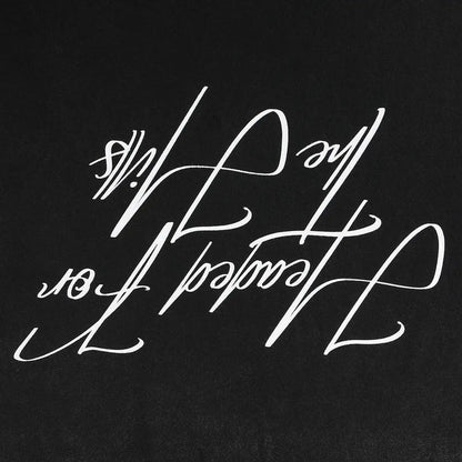Black T-shirt close-up of large white script graphic lettering