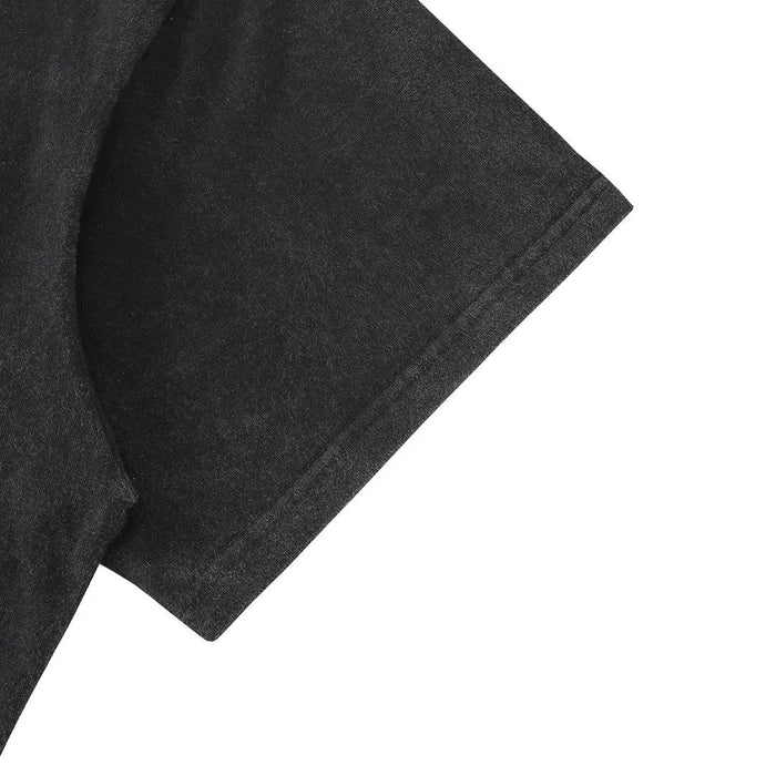 Black T-shirt sleeve close-up with textured fabric finish