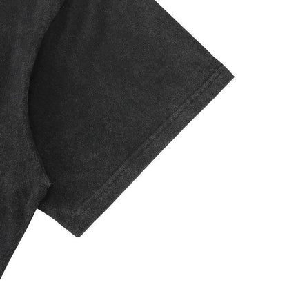 Black T-shirt sleeve close-up with textured fabric finish