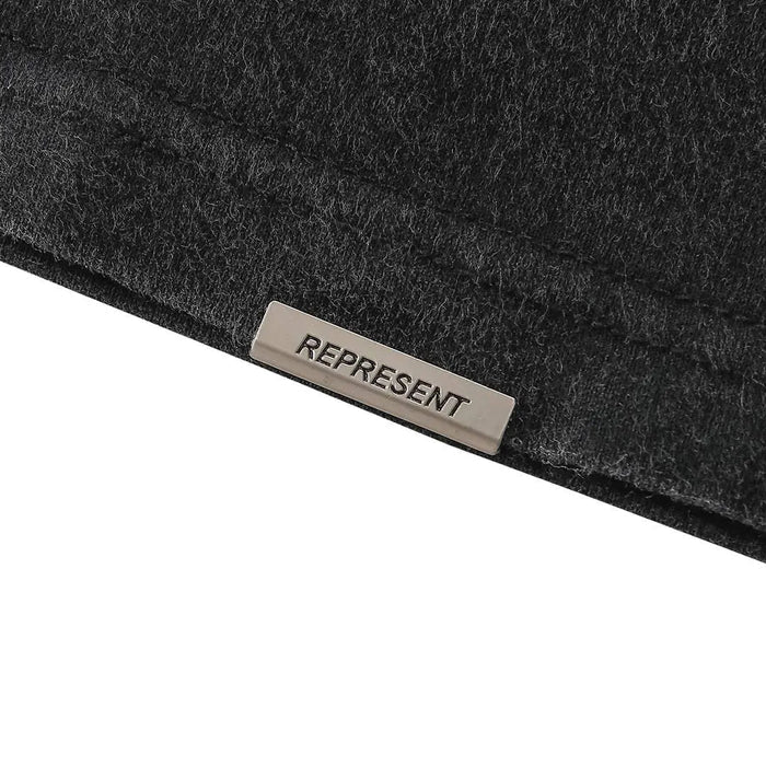 Black T-shirt neck label reading REPRESENT on inner collar seam