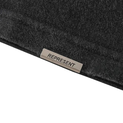 Black T-shirt neck label reading REPRESENT on inner collar seam