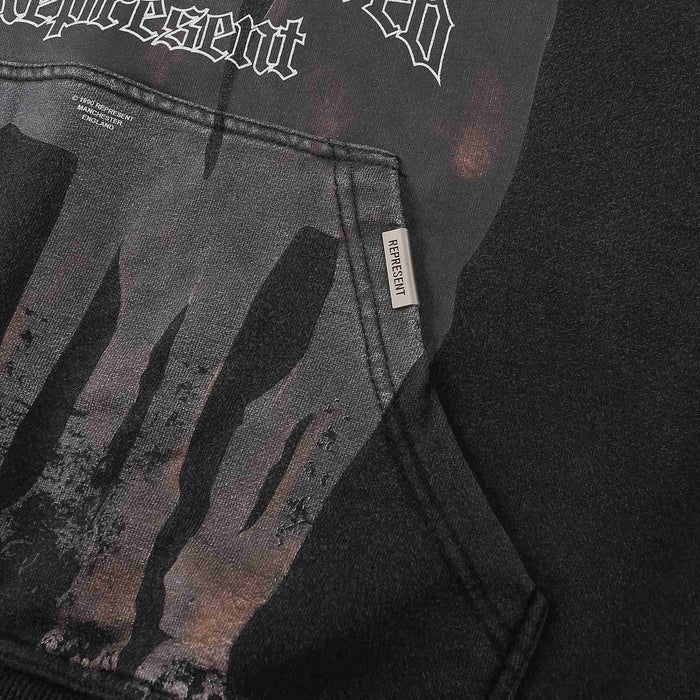 Black hoodie front pocket with dog graphic and small brand label