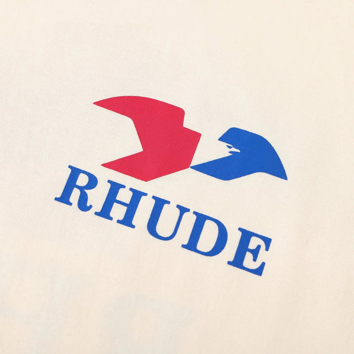 Cream T-shirt chest graphic with red and blue Rhude logo